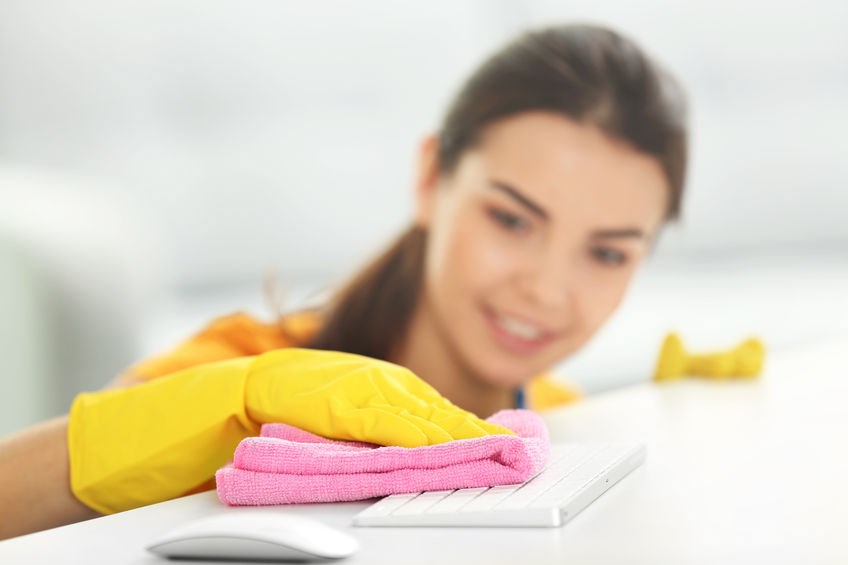 Women wiping down a keyboard