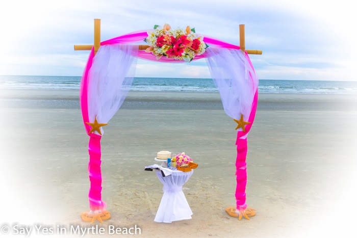 Magenta and white tulle wrapped arbor