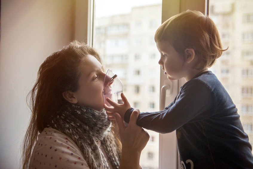 Woman and child holding a ventilator mask